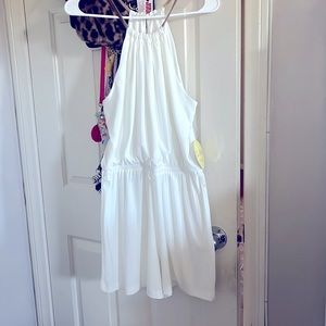 White dressy romper with gold neckline straps. Brand new never worn.